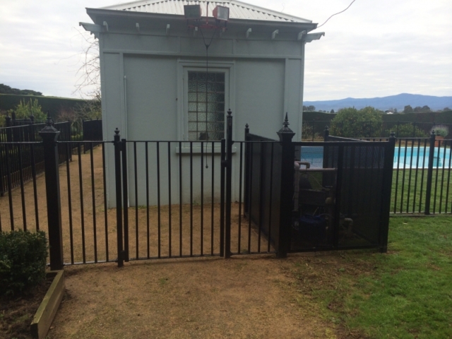 Black wrought iron pool fence and pedestrian gate Black wrought iron pool fence and pedestrian gate