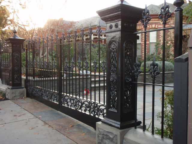 Black wrought iron fence and double swing gates Black wrought iron fence and double swing gates