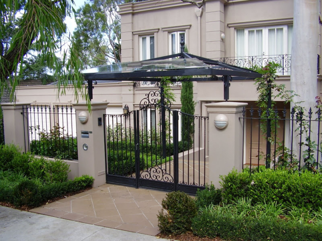 Black wrought iron fence and swing gate Black wrought iron fence and swing gate