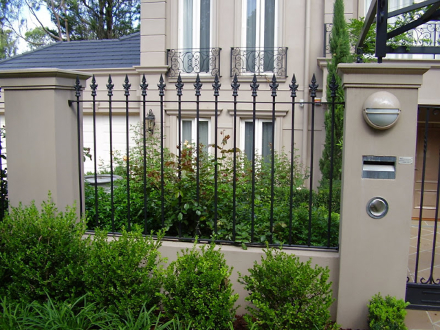 Black wrought iron fence and swing gate Black wrought iron fence and swing gate