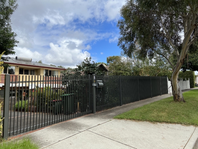 Steel blade fence with sliding gate steel-blade-fence-sliding-gate